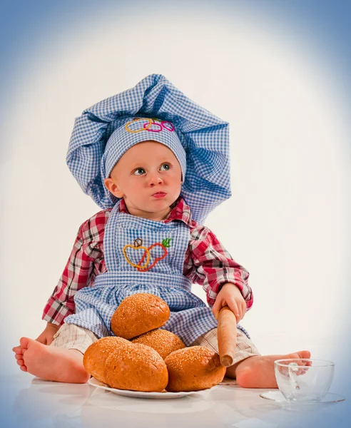 stock image Little cook. Cute kitchen-boy with tasty patties and kitchen accessories