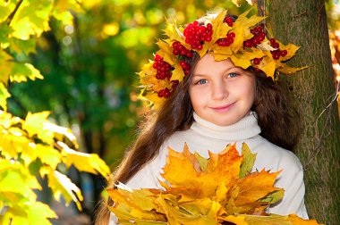 Cute smiling girl in a wreath of red viburnum on the head and with a bouque clipart