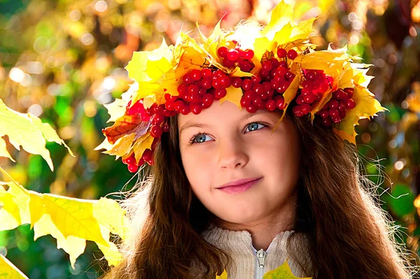 Cute smiling girl in a wreath of red viburnum on the head and with a bouque — Stock Photo, Image