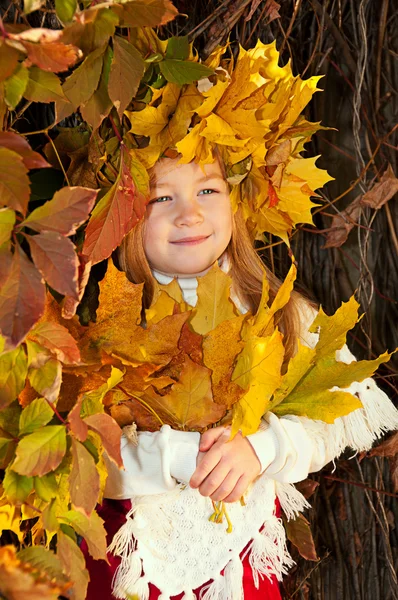 Cute smiling girl in a wreath of red viburnum on the head and with a bouque — Stock Photo, Image