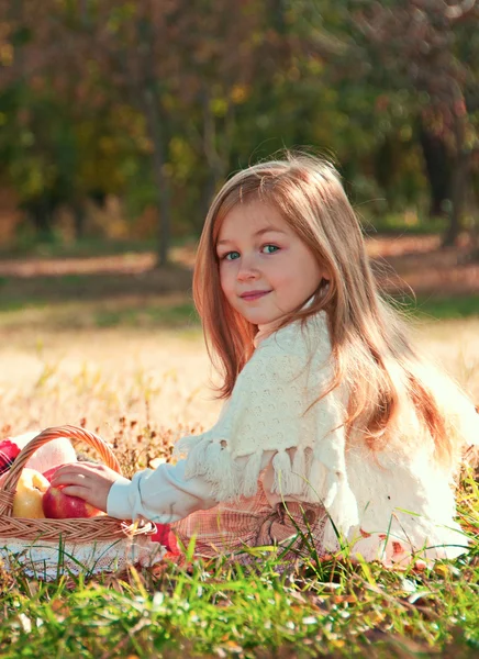 Beautiful little girl with a basket in anticipation. — Stock Photo, Image