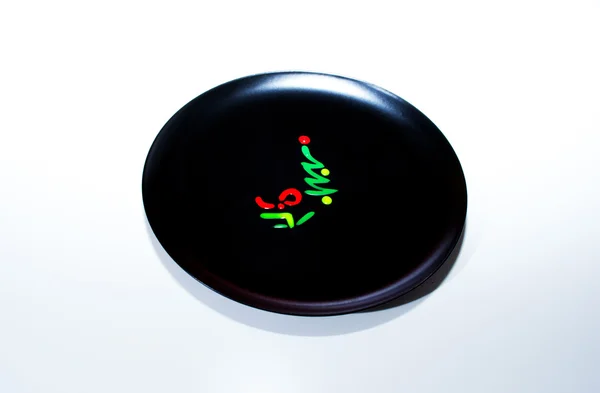 Der schwarze Teller mit der Neujahrszeichnung auf ihr — Stockfoto