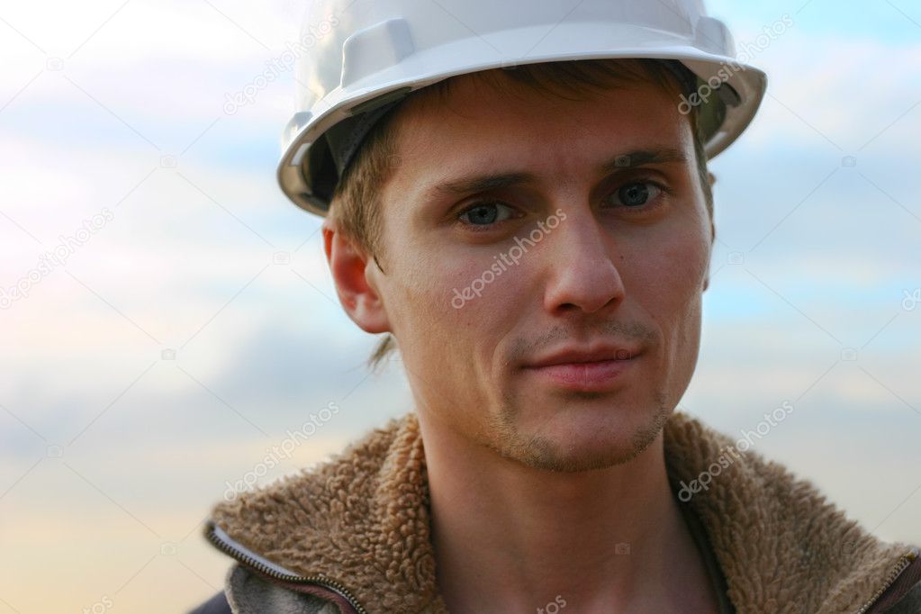 Man in helmet young builder