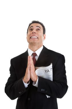 Businessman Holding Business Section Newspaper Looking Up Prayin clipart