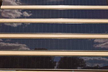 Rows of Louvered Solar Panels, Reflection Sky Trees clipart