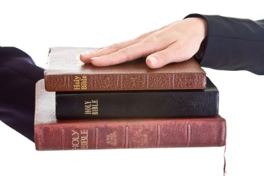 Woman's Hand Stack of Bibles Isolated Background clipart