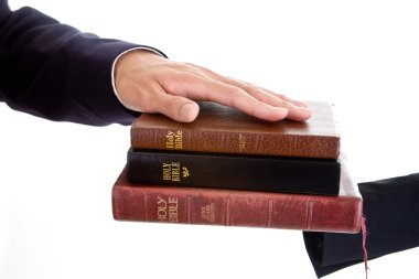 Man's Hand Stack of Bibles, Isolated Background clipart