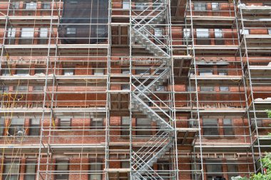 Scaffolding Old Brick Building Under Renovation clipart