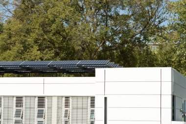 Modern Solar Home with Row PV Panels on Roof clipart