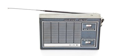 Vintage AM and Police Band Transistor Radio On White Background clipart