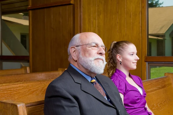 stock image Senior Caucasian Man and Young Woman Sitting in Church Pew