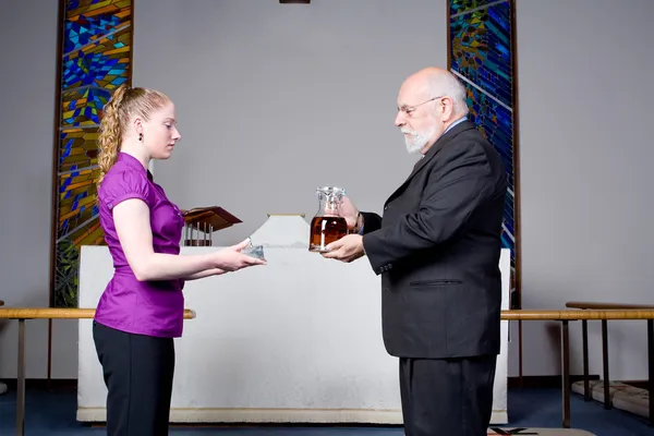 stock image Senior Man Young Woman Holding Wine, Bread, Communion in Church