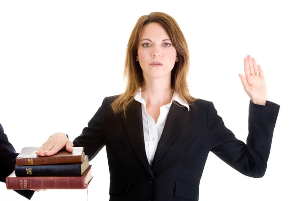 Caucasian Woman Swearing on a Stack of Bibles White Background — Stock Photo, Image