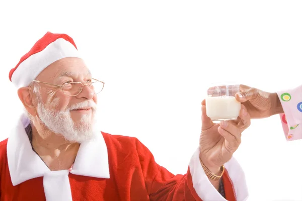 Santa tomando copo de leite de mão isolado — Fotografia de Stock