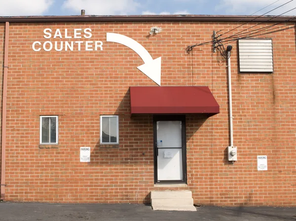 Freccia e parole Brick Wall Point to Sales Counter — Foto Stock