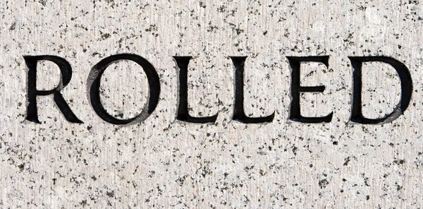 Parola "laminato" intagliato in pietra di granito grigio — Foto Stock