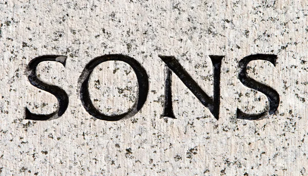 Word "Sons" Carved in Gray Granite Stone — Stock Photo, Image