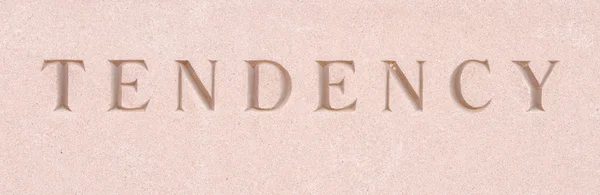 Slovo "tendence" vytesaný do pískovce kamene — Stock fotografie