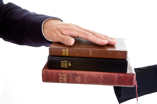 Man 's Hand Stack of Bibles, Isolated Background
