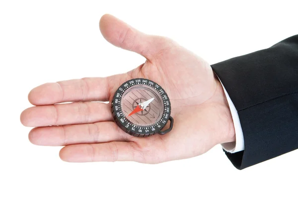 Man's Hand met duidelijk kompas geïsoleerd op witte achtergrond — Stockfoto