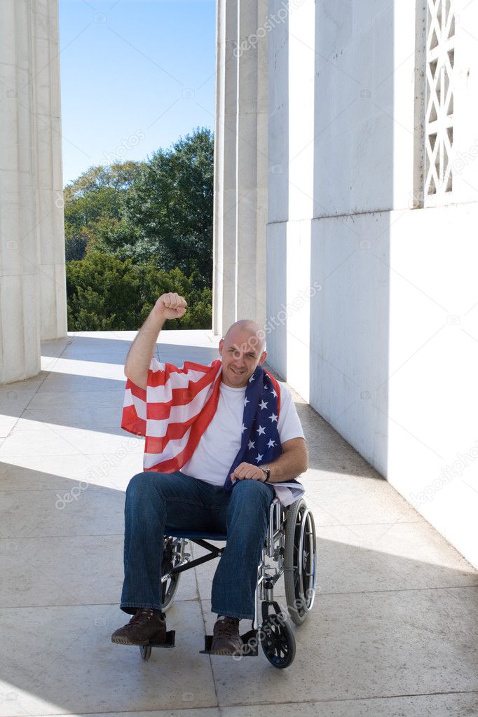 Man Wheelchair American Flag Raised Fist Blue Sky