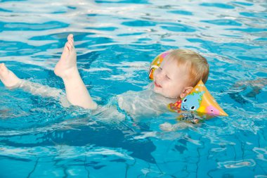 Baby bathes in a pool clipart