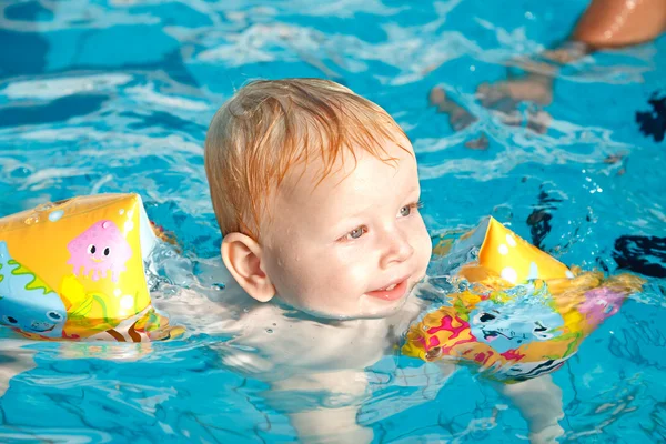 stock image Little boy floating in pool