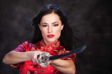 Pretty kimono woman in action with katana sword clipart