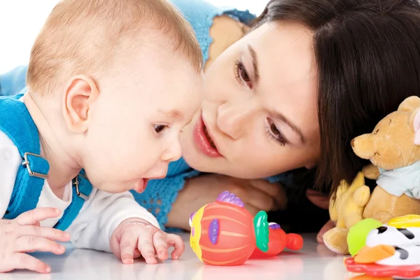 Baby surprisely looking at the plastic fish — Stock Photo, Image