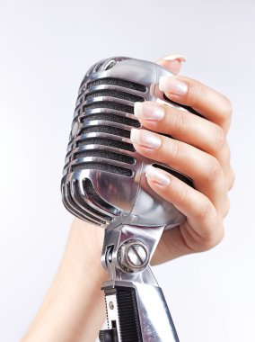 Big microphone in woman's hand clipart