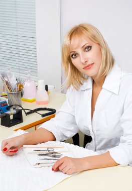 Manicurist portrait in interior of nail salon clipart