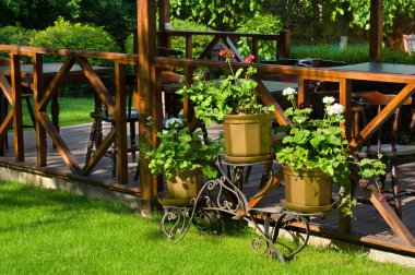 Open air cafe with lots of green plants clipart