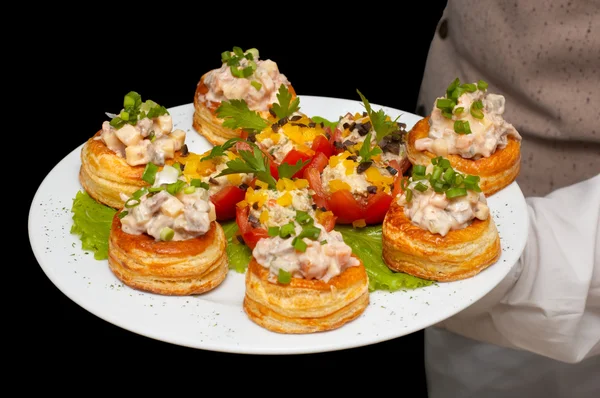 Tartlets with salad on dish — Stock Photo, Image