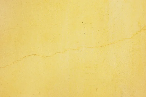 Yellow stucco with crack — Stock Photo, Image