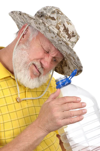 stock image Senior man looking into empty bottle