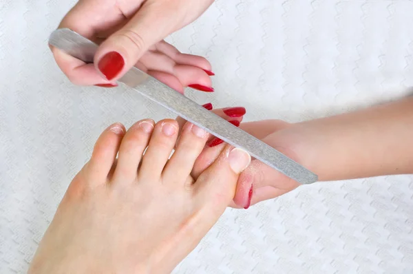 Applying pedicure, using nail file — Stock Photo, Image