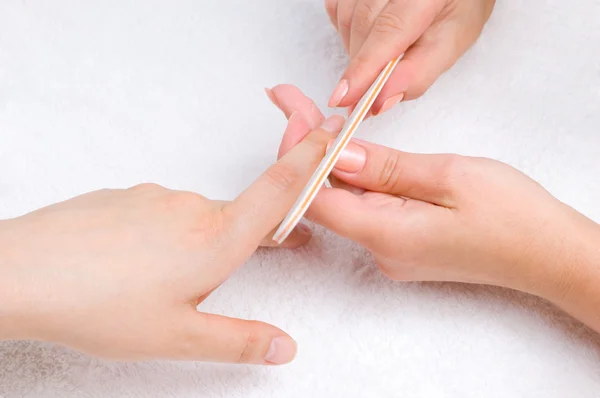 Applying manicure with nail-file — Stock Photo, Image