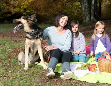 Mother with two doughters and a dog clipart