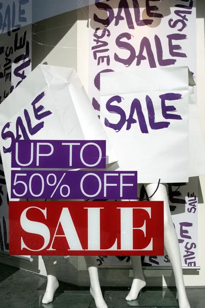 stock image The word Sale on paper bags in shopping window