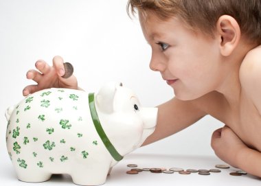 Kid with a piggy bank clipart