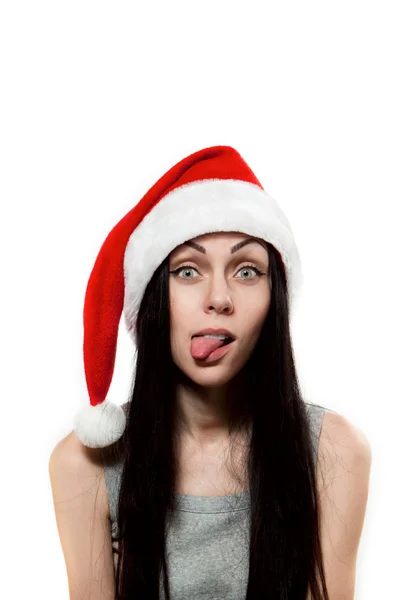 Girl in Santa Clause hat put out one's tongue — Stock Photo, Image