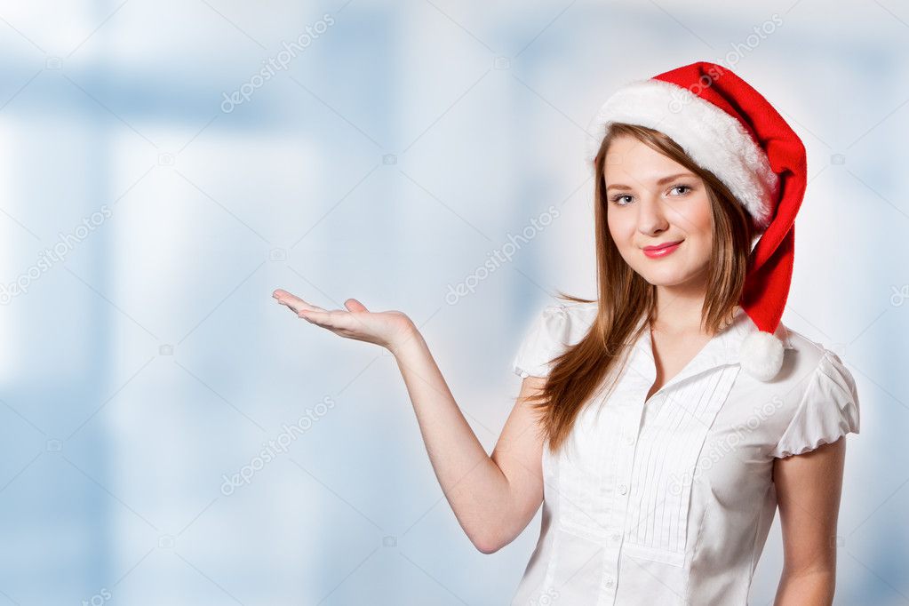 Young attractive woman holds palm for blank ad space