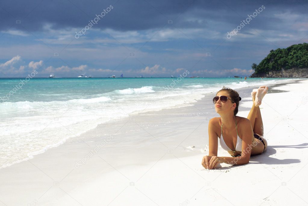 Young attractive woman in a bikini on tropical island