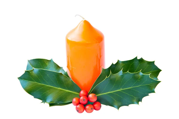 The candle is decorated with holly leaves and berries — Stock Photo, Image