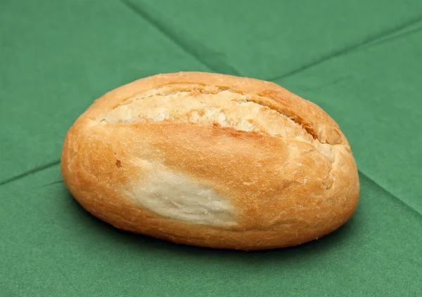 Wheat roll on the green napkin. — Stock Photo, Image