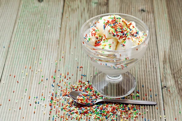 Ice cream with the sugar chips on a wooden table — Stock Photo, Image