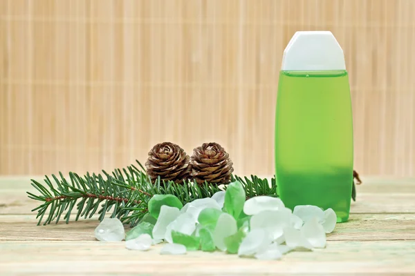 Coniferous extract bath with a sprig of pine needles, pine cones and bath s — Stock Photo, Image