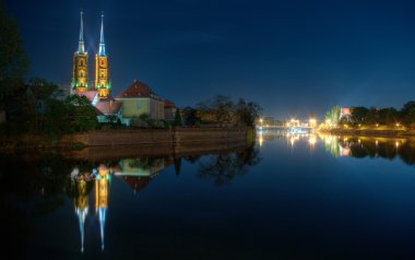 Wroclaw's night scene with cathedral and river clipart