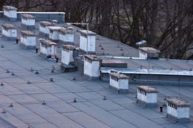 Flat roof with many chimneys clipart