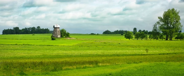 Spring panorama with old windmill — Stock Photo, Image